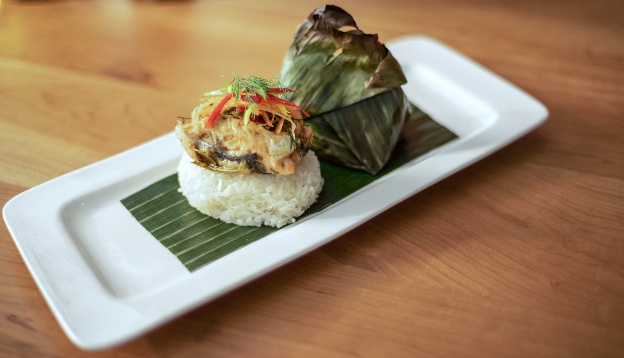Thai dish presented with rice and banana leaf